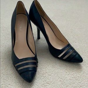 Black pointed toe high heels.